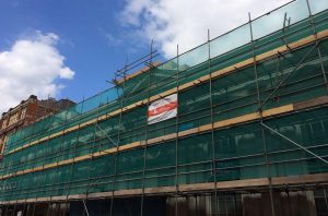 Traditional scaffolding with green netting
