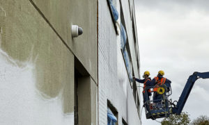 An MEWP being used to redecorate a brick and render building