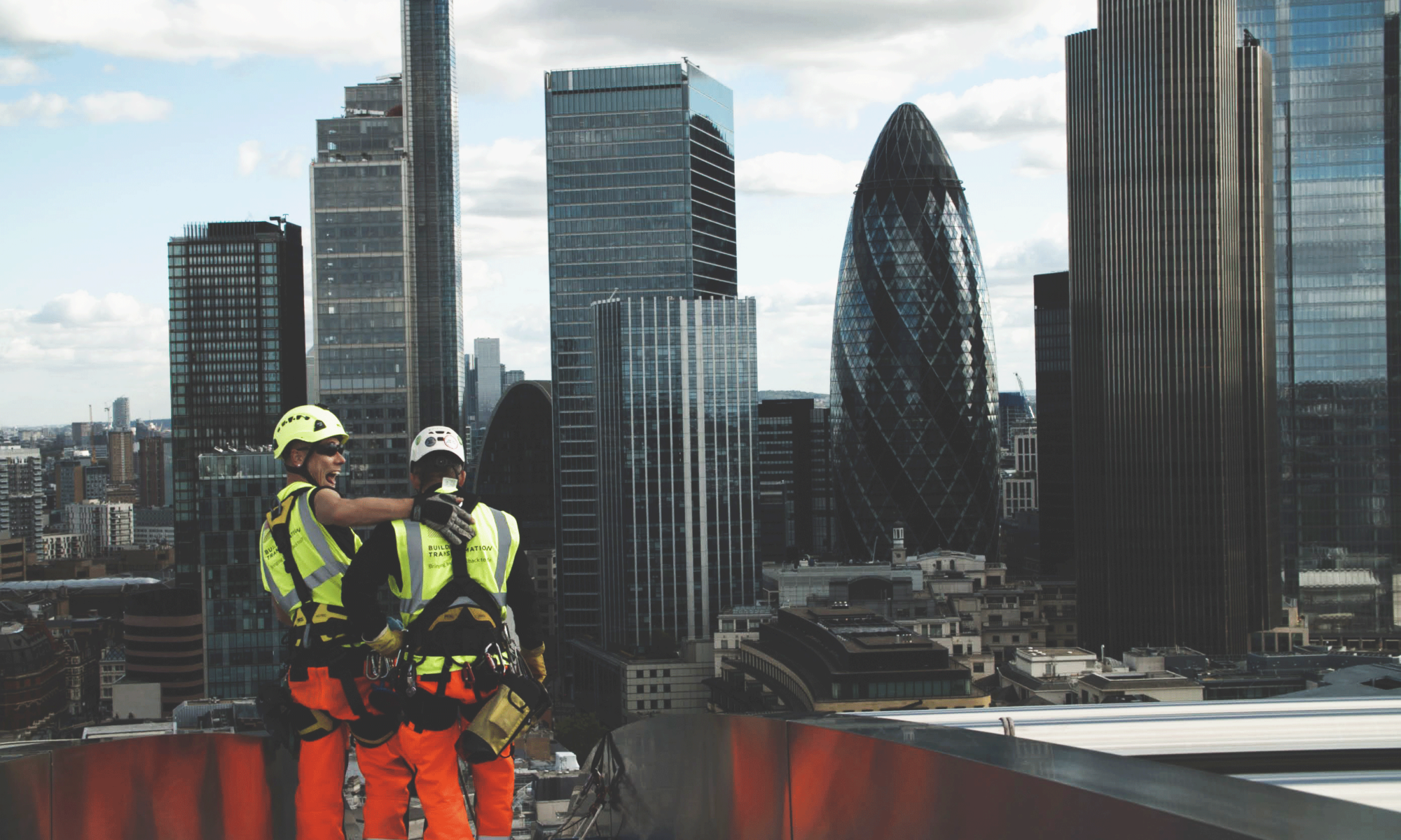 Building Transformation employees laughing together with London Skyline in the background