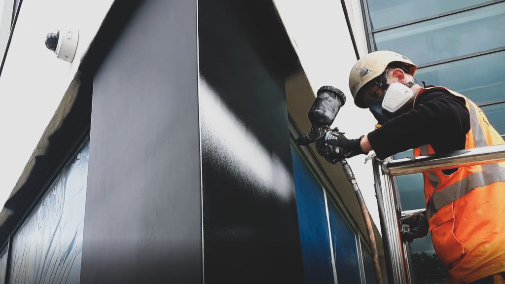 powder coating and spraying aluminium window frames with black paint